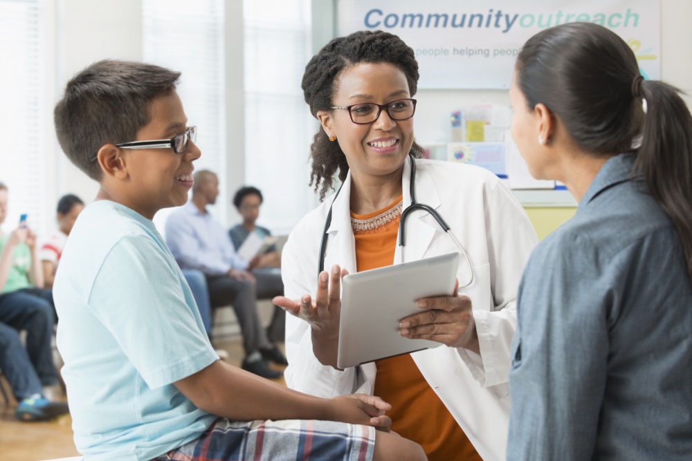 doctor talking to mother and son in hospital